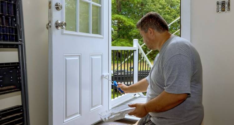 person painting front door