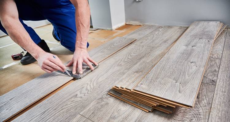 man measuring flooring