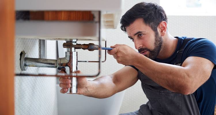 man under sink