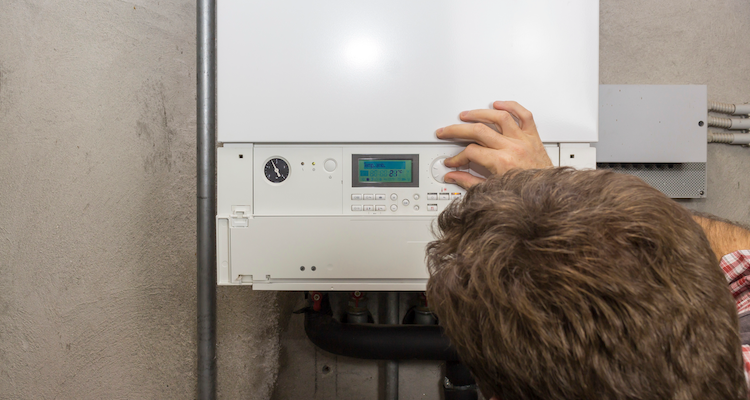 tradesperson configuring a boiler after relocation