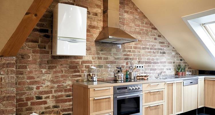 boiler installation cost guide — new boiler fitted onto the wall after a house renovation