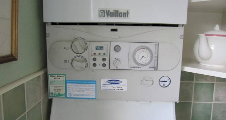 boiler installation cost guide — old boiler being replaced for modern model