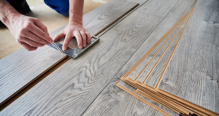 laminate flooring being measured during an installation job