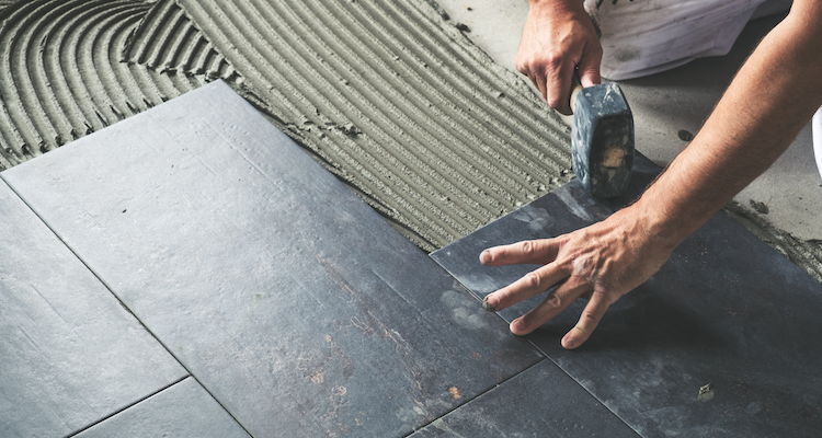 tiled flooring being installed by a tradesperson