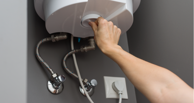 a heating engineer opening up the front of a UK boiler