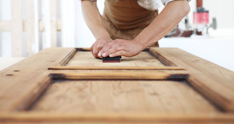 person sanding door