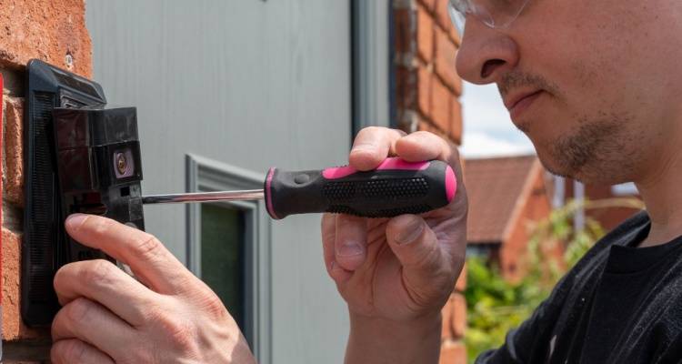 man fitting smart doorbell