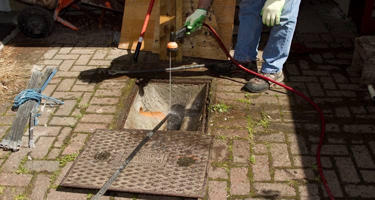 Open manhole being cleaned