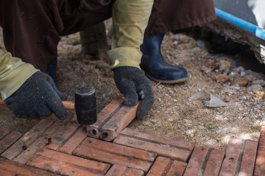 person installing block paving driveway