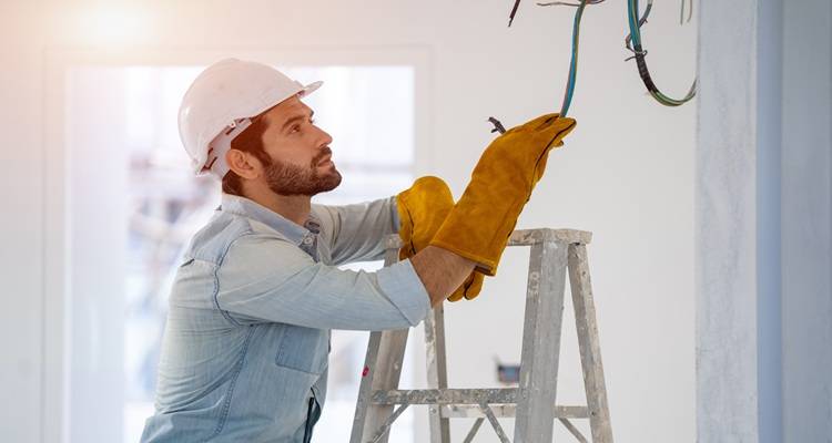 man wiring ceiling light