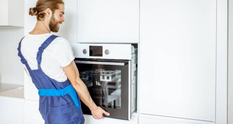 person installing an electric oven