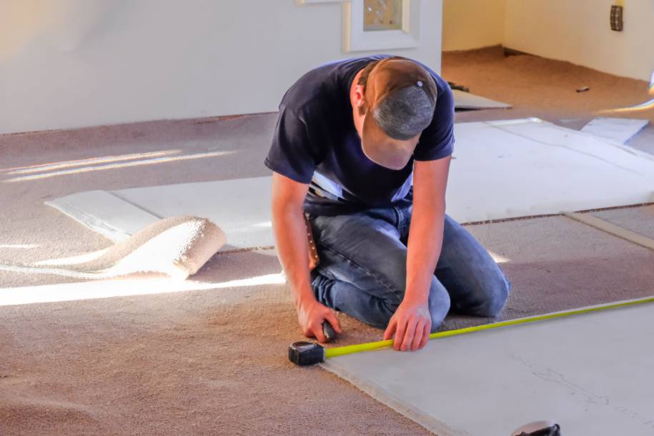 person installing carpet