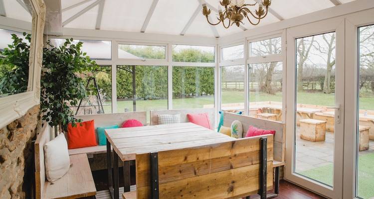 house extension cost guide — a conservatory that is being used as a dining area