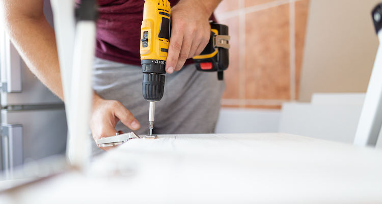 carpenter dismantling a fitted wardrobe