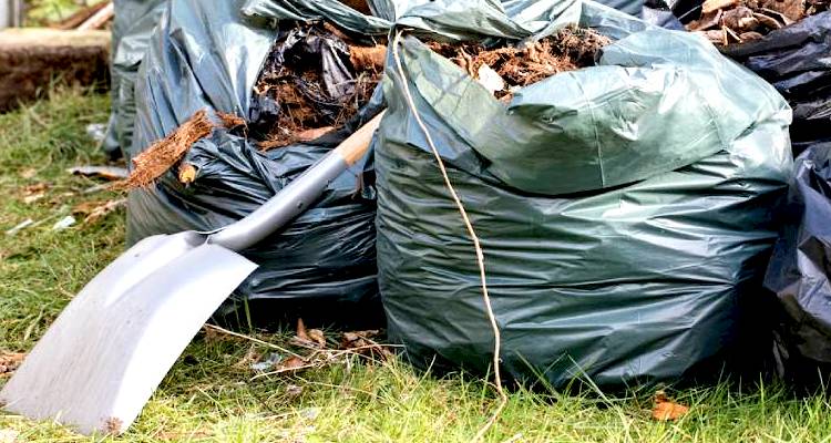 bags of garden waste and a spade