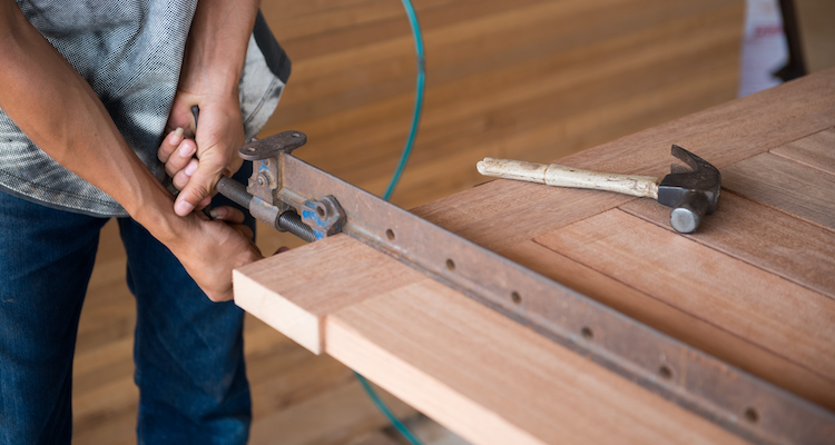 custom-made front door being constructed by a tradesperson