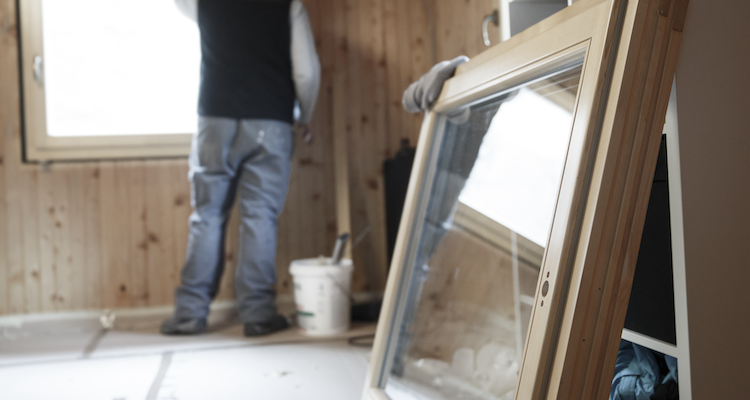 joiner fitting a new wooden window