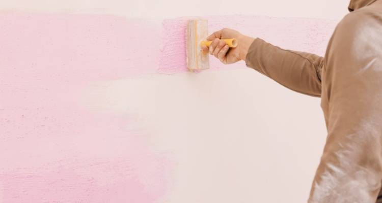 person painting a room