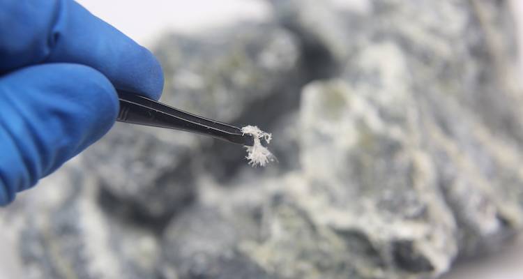 closeup of asbestos held by tweezers