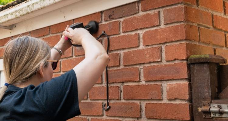 woman installing cctv