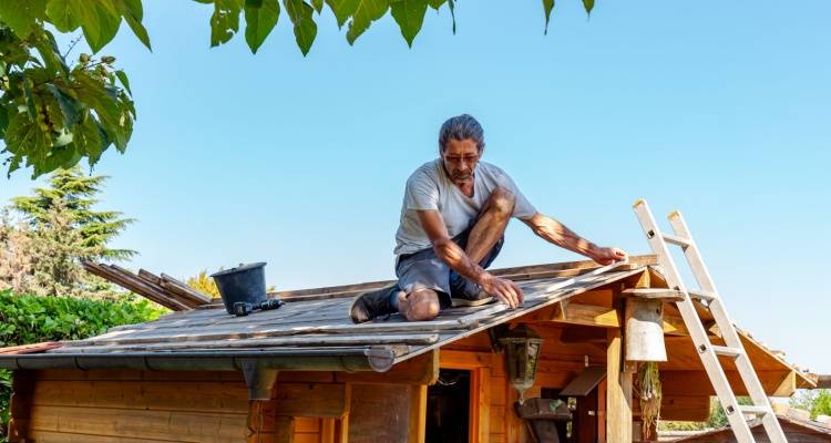 person repairing shed roof
