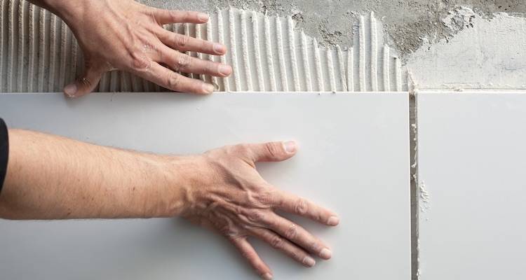 mason hands on wall tiles