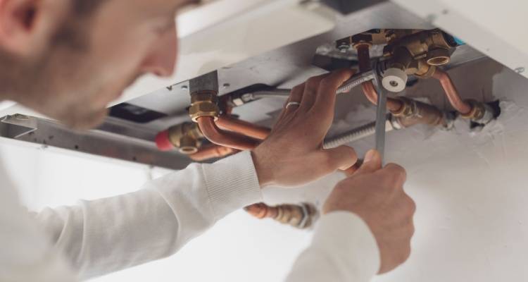 person repairing boiler