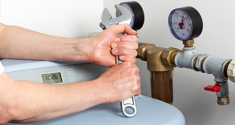 man installing water softener