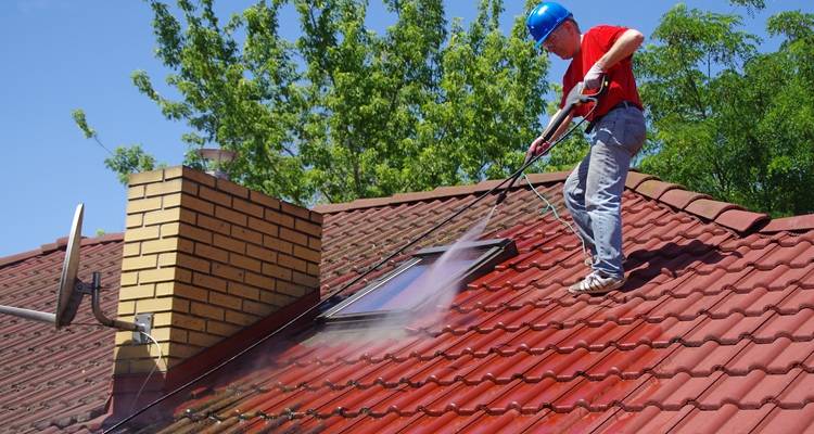 man cleaning roof